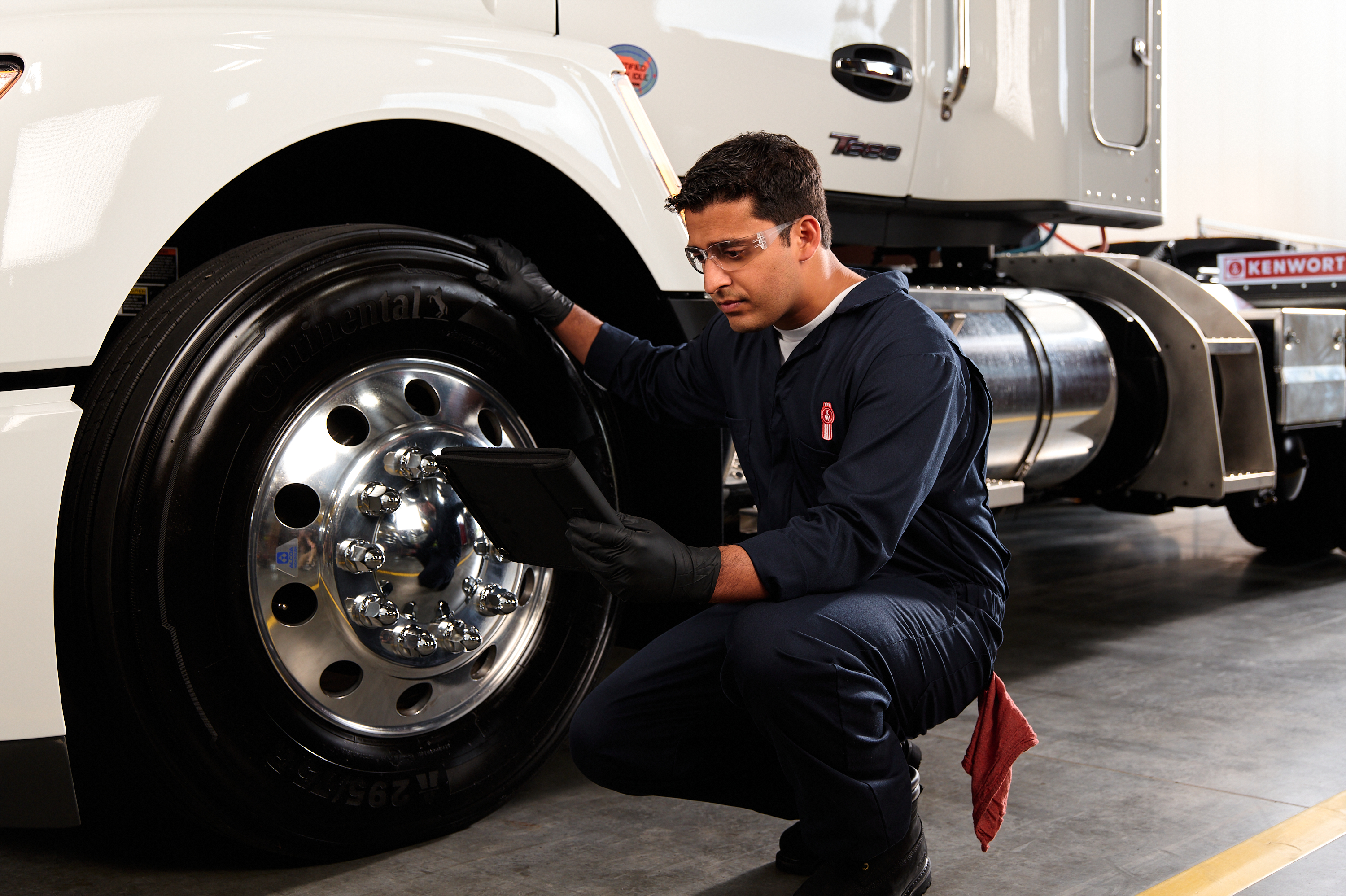 A Kenworth technician services a truck